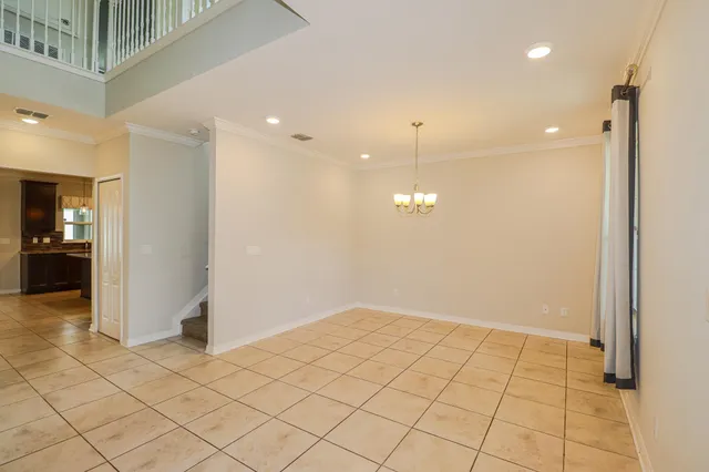 an empty room with kitchen view