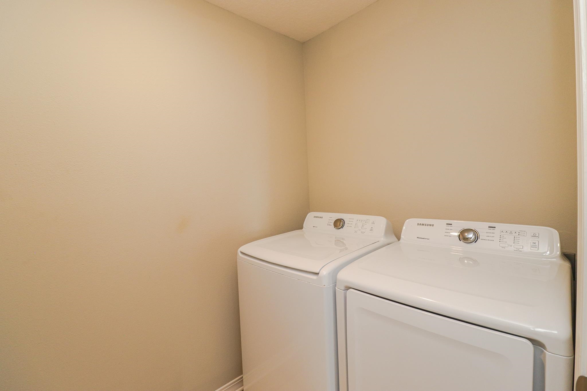 554 Tumbled Stone Way St. Augustine, FL 32086 - Photo 31 of 44 a utility room with dryer and washer