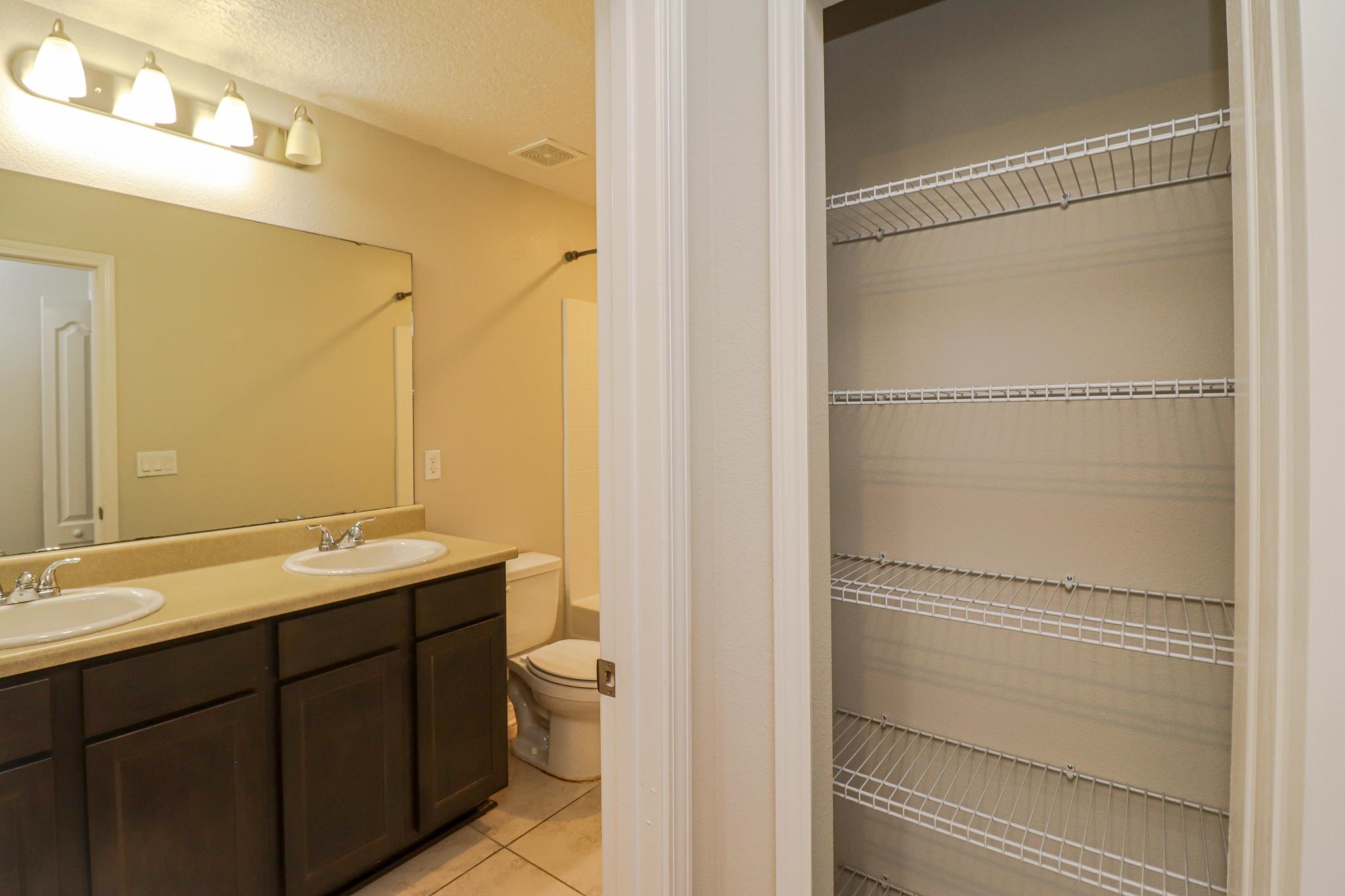 554 Tumbled Stone Way St. Augustine, FL 32086 - Photo 37 of 44 a bathroom with a granite countertop sink mirror and a toilet