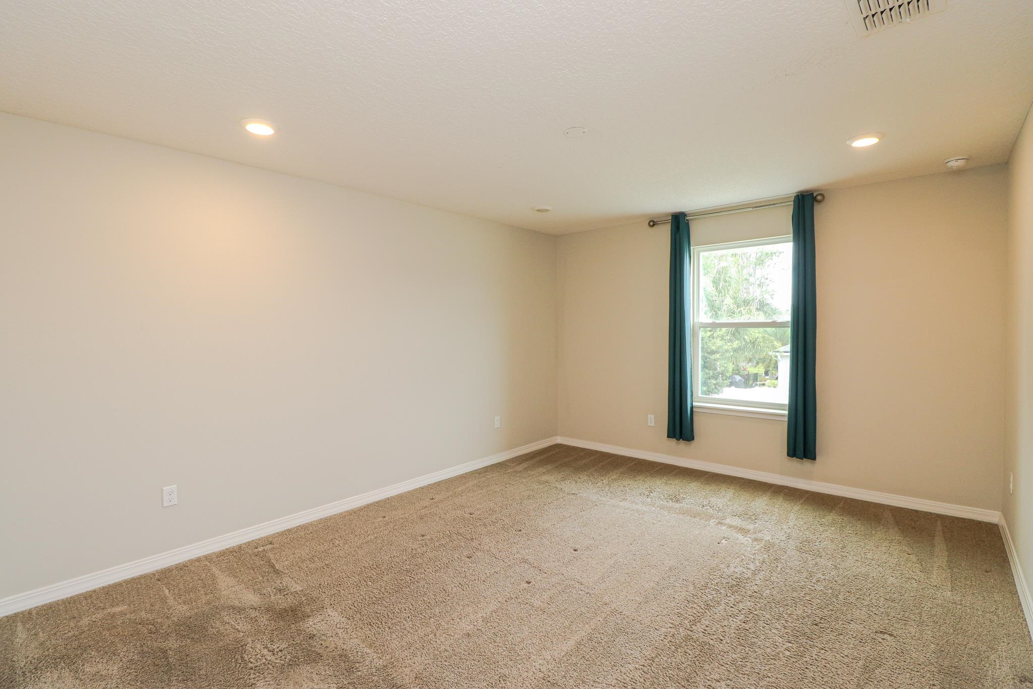 554 Tumbled Stone Way St. Augustine, FL 32086 - Photo 38 of 44 an empty room with windows