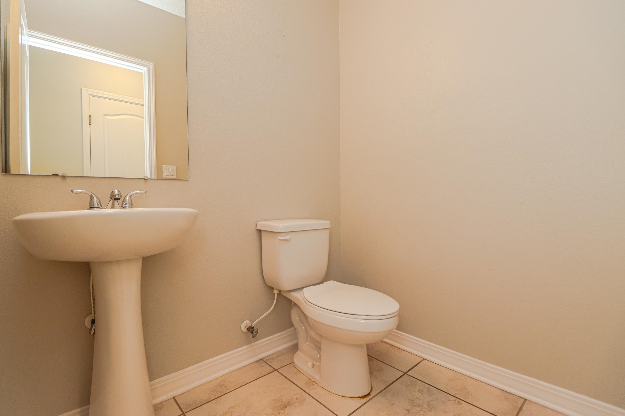 554 Tumbled Stone Way St. Augustine, FL 32086 - Photo 5 of 44 a bathroom with a sink toilet and a mirror
