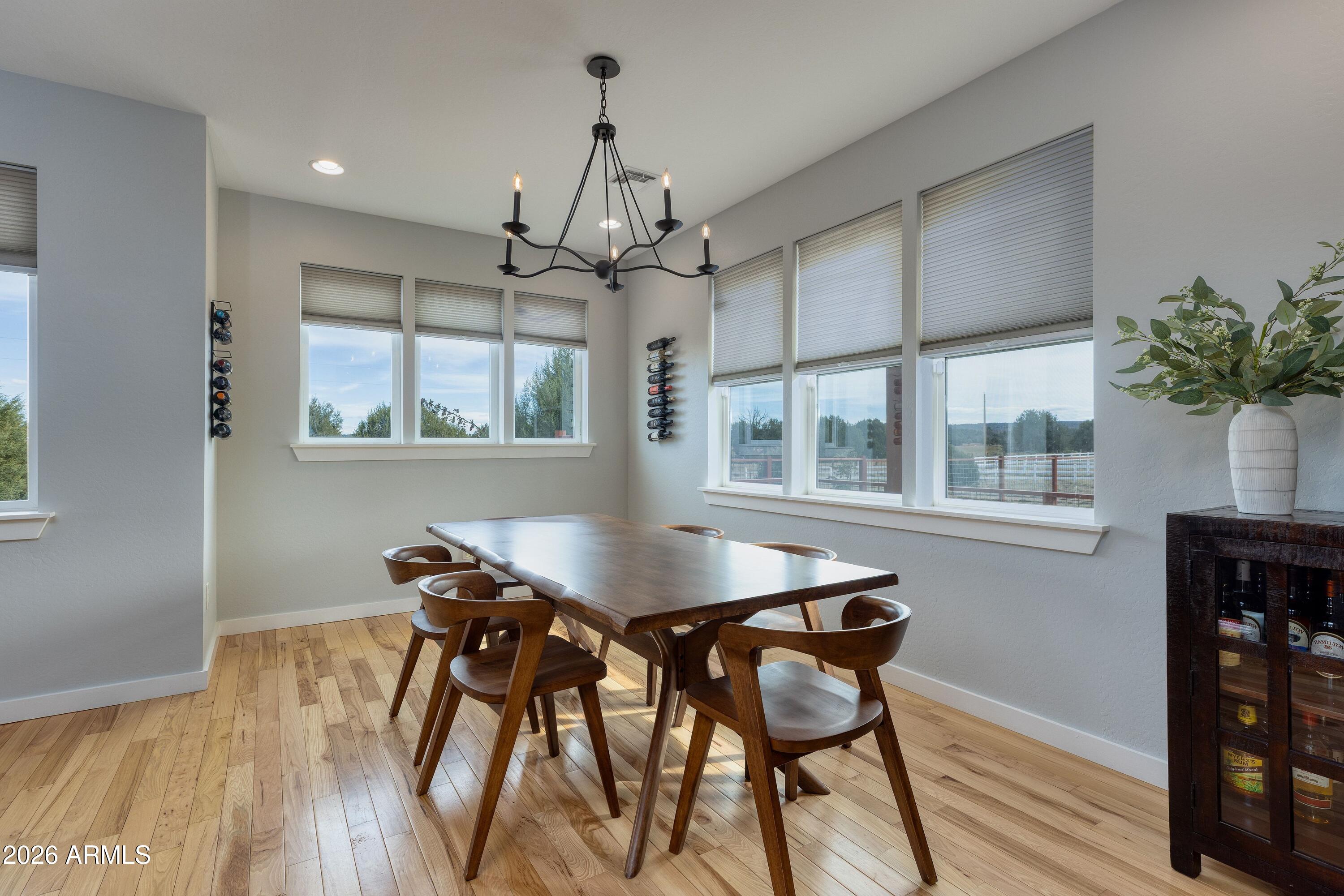 1898 Rocky Lane Show Low, AZ 85901 - Photo 21 of 59 a dining room with furniture a chandelier and wooden floor