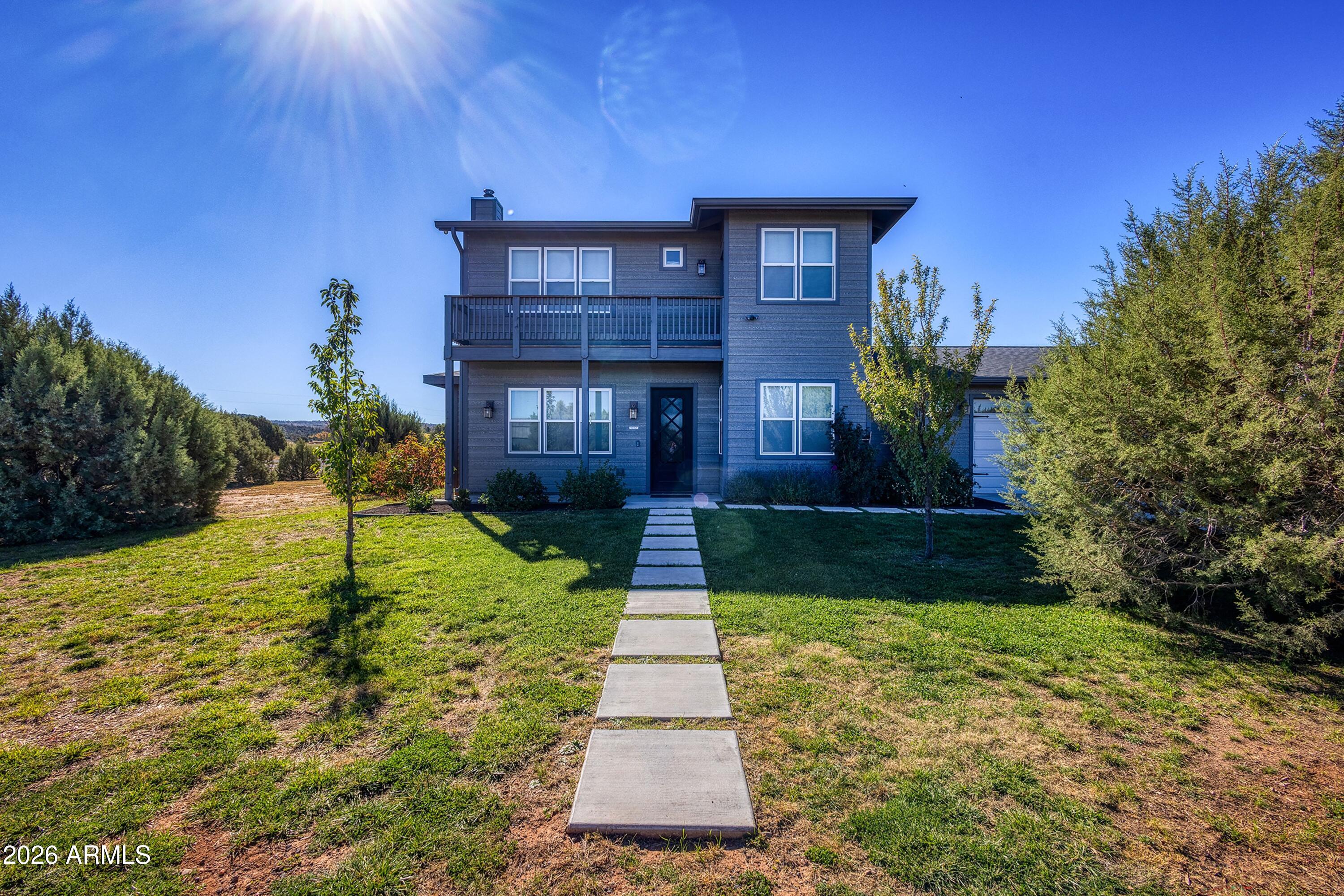 1898 Rocky Lane Show Low, AZ 85901 - Photo 4 of 59 a front view of a house with garden