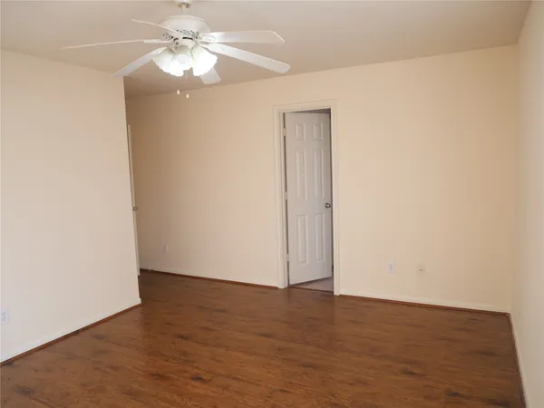 a view of an empty room with a fan