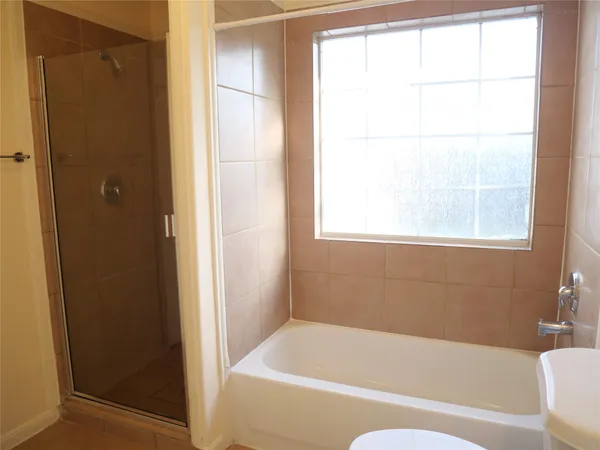 a bathroom with a bathtub and a window