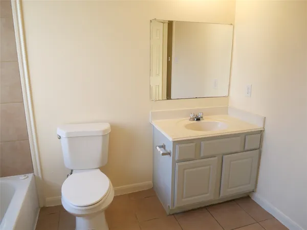 a bathroom with a sink toilet and mirror