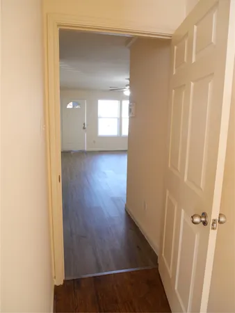 a view of a hallway with wooden floor
