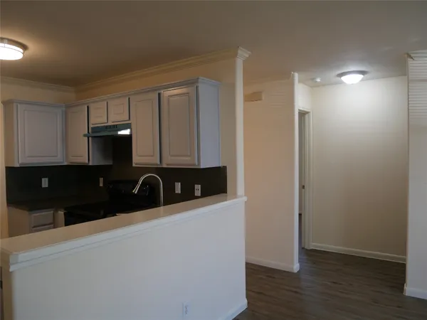 a close view of a refrigerator a sink and cabinets