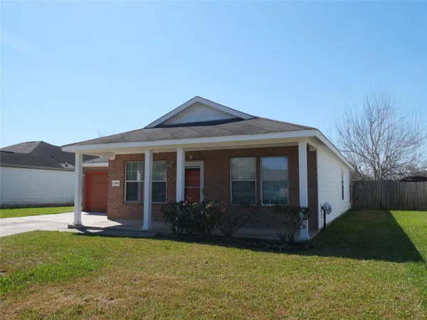 a front view of a house with a garden and yard