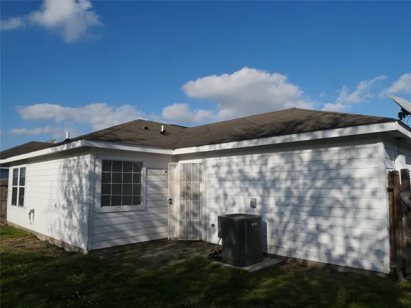 a backyard of a house with table and chairs