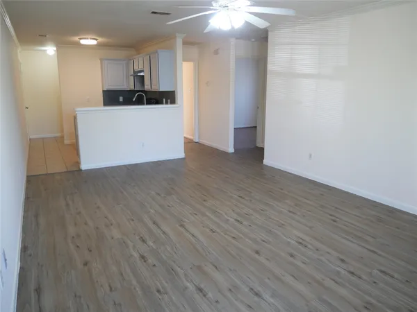 a view of a kitchen with wooden floor and a sink