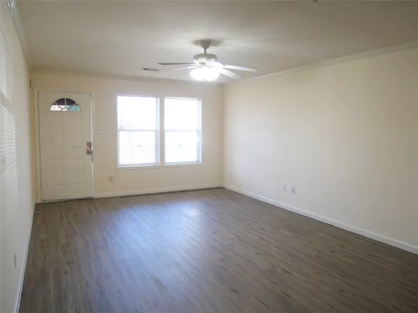 wooden floor in an empty room with a window