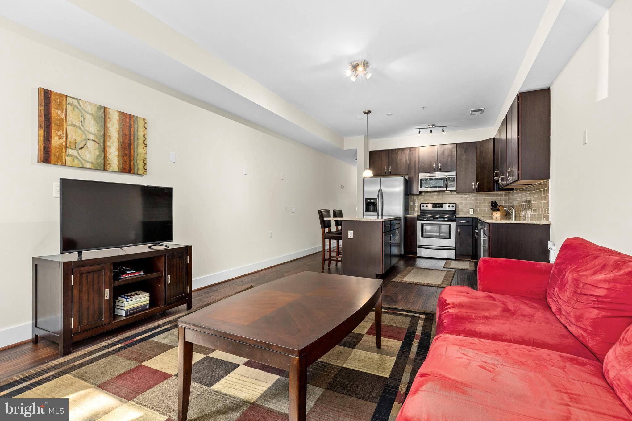 245 15th Street Southeast, Unit 105 Washington, DC 20003 - Photo 11 of 29 a living room with furniture and a flat screen tv