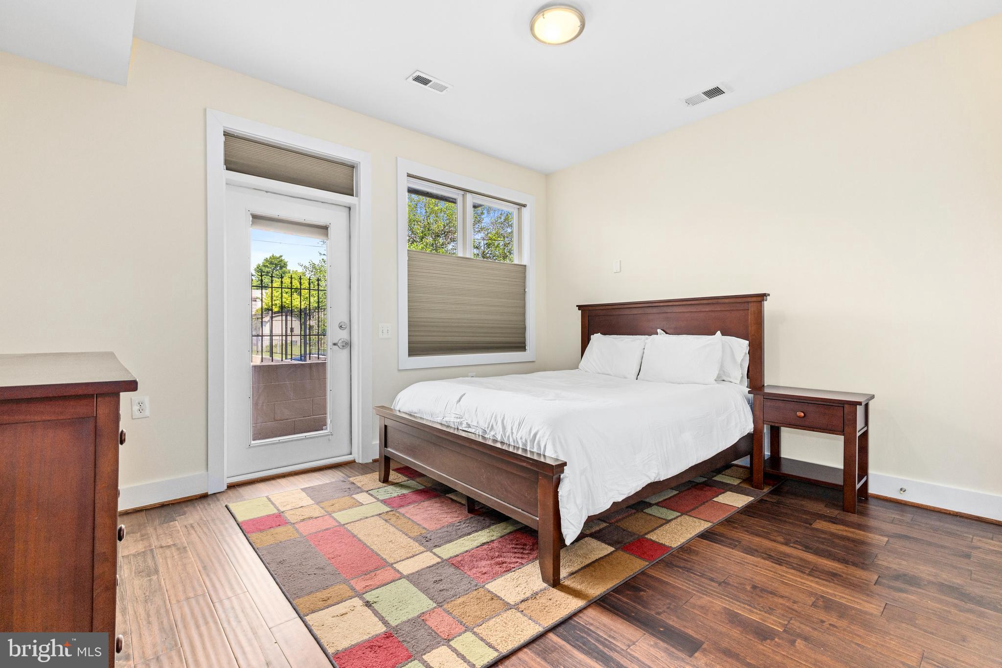 245 15th Street Southeast, Unit 105 Washington, DC 20003 - Photo 13 of 29 a bedroom with a bed and a table
