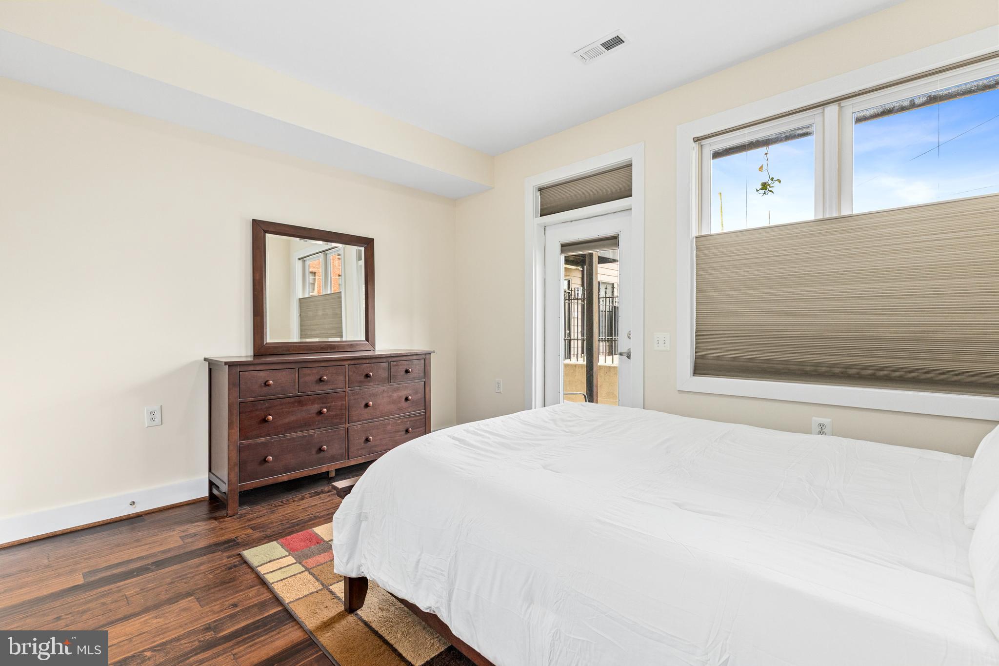 245 15th Street Southeast, Unit 105 Washington, DC 20003 - Photo 14 of 29 a bedroom with a bed and a dresser