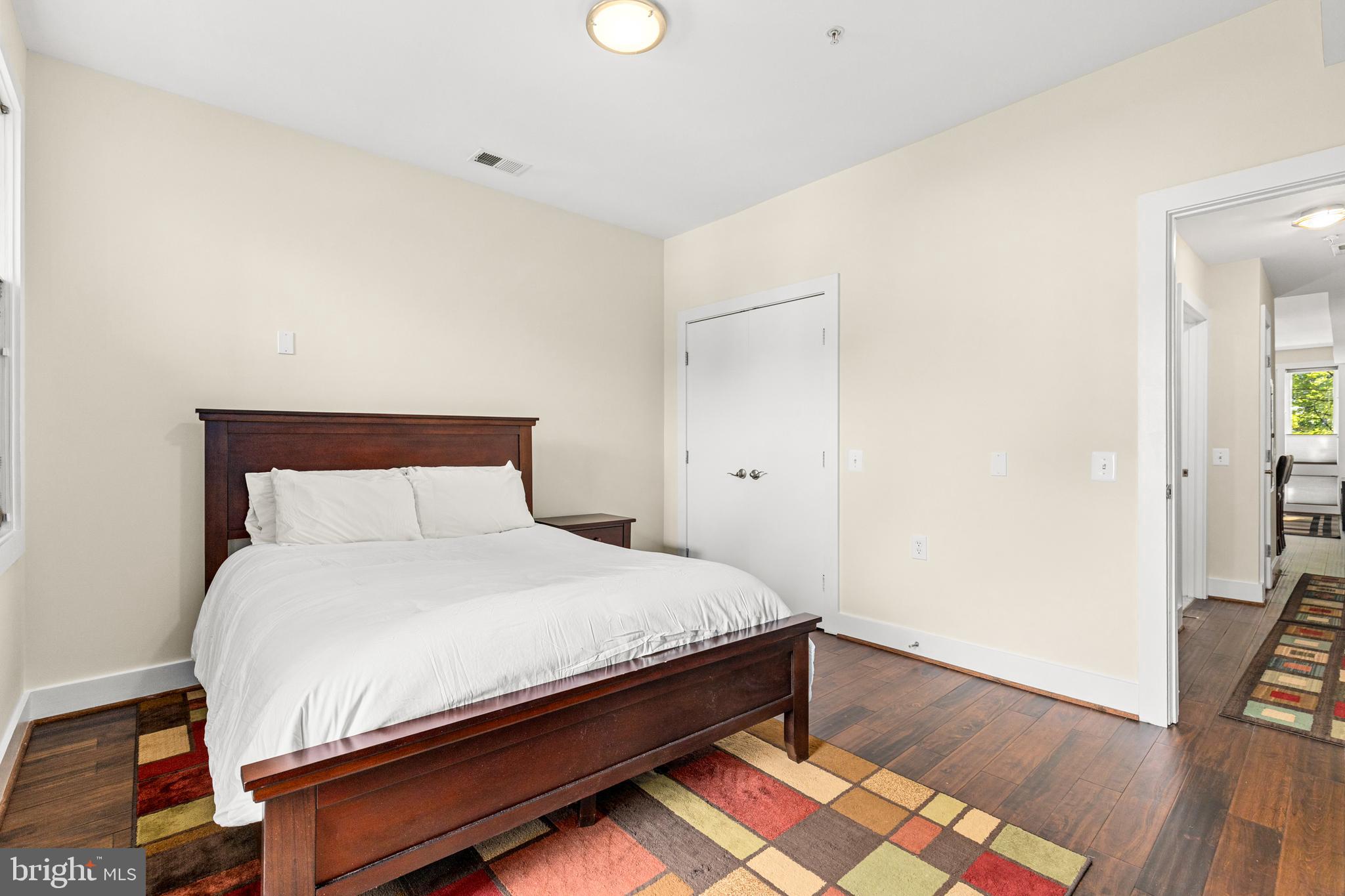 245 15th Street Southeast, Unit 105 Washington, DC 20003 - Photo 15 of 29 a large bed sitting in a bedroom next to a cabinet