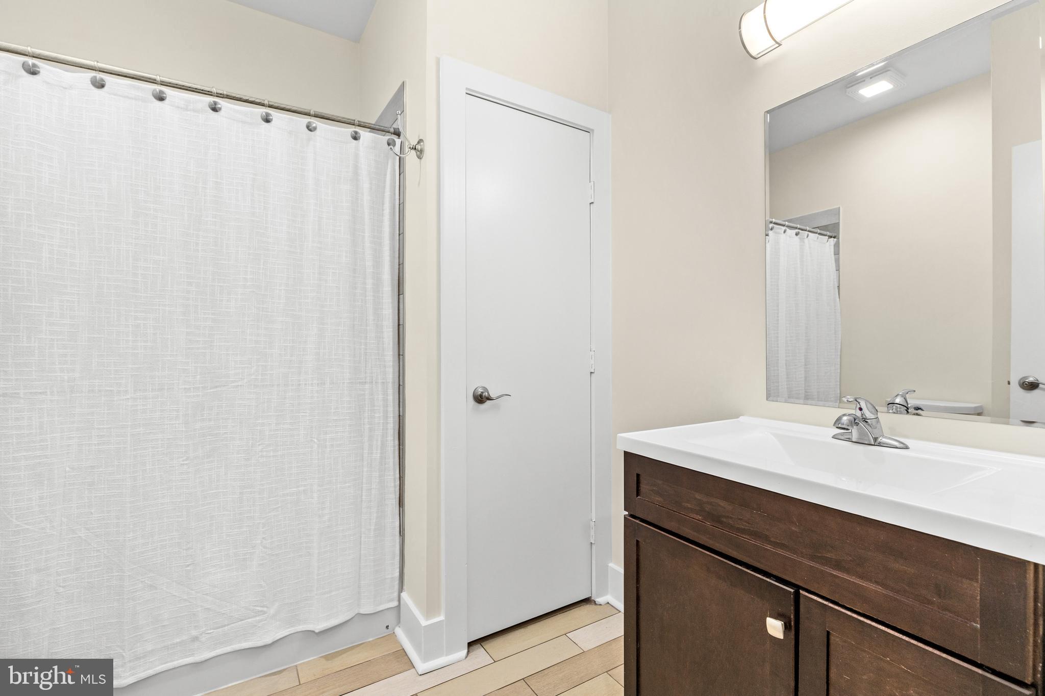 245 15th Street Southeast, Unit 105 Washington, DC 20003 - Photo 17 of 29 a bathroom with a sink and a mirror