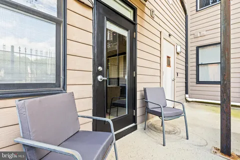 a view of a chairs and table in the balcony