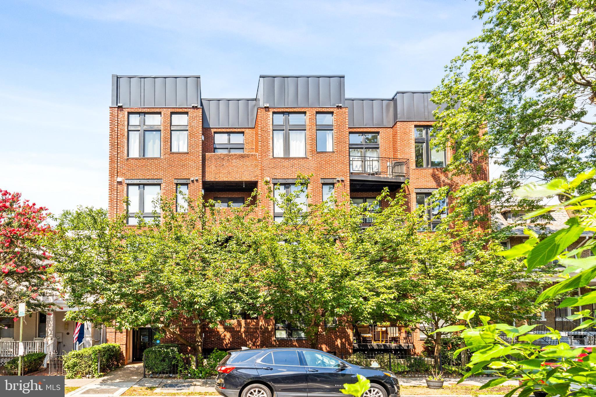 245 15th Street Southeast, Unit 105 Washington, DC 20003 - Photo 26 of 29 a flower garden is sitting in front of a building