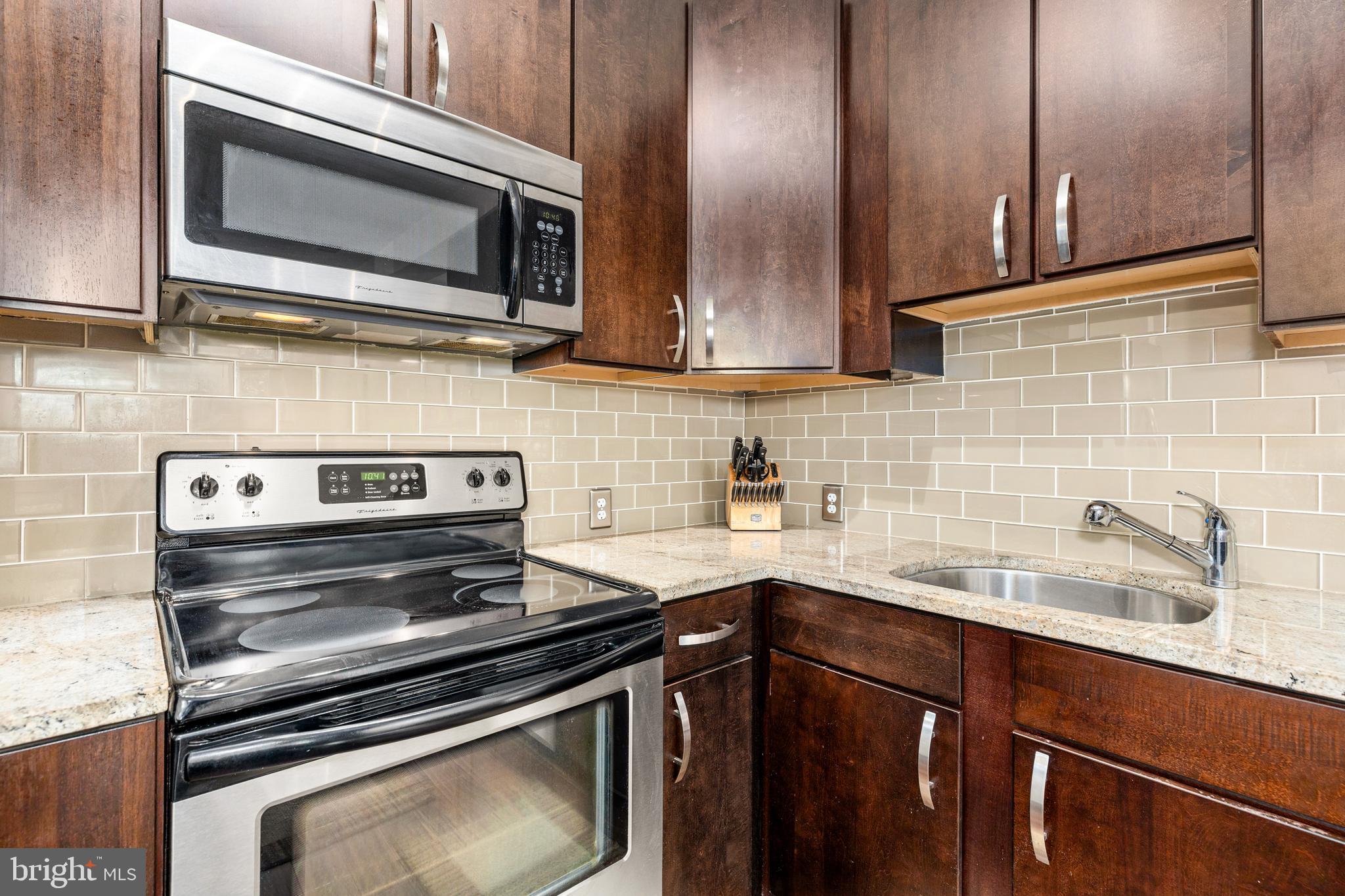 245 15th Street Southeast, Unit 105 Washington, DC 20003 - Photo 4 of 29 a kitchen with a sink stove and microwave