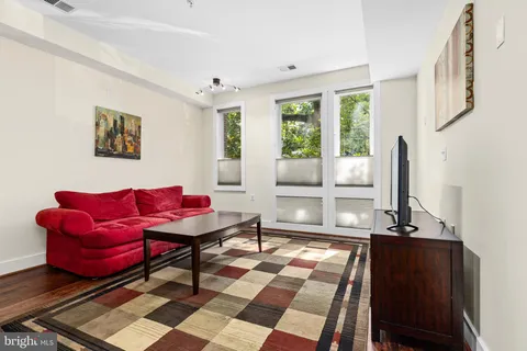 a living room with lots of furniture and kitchen view