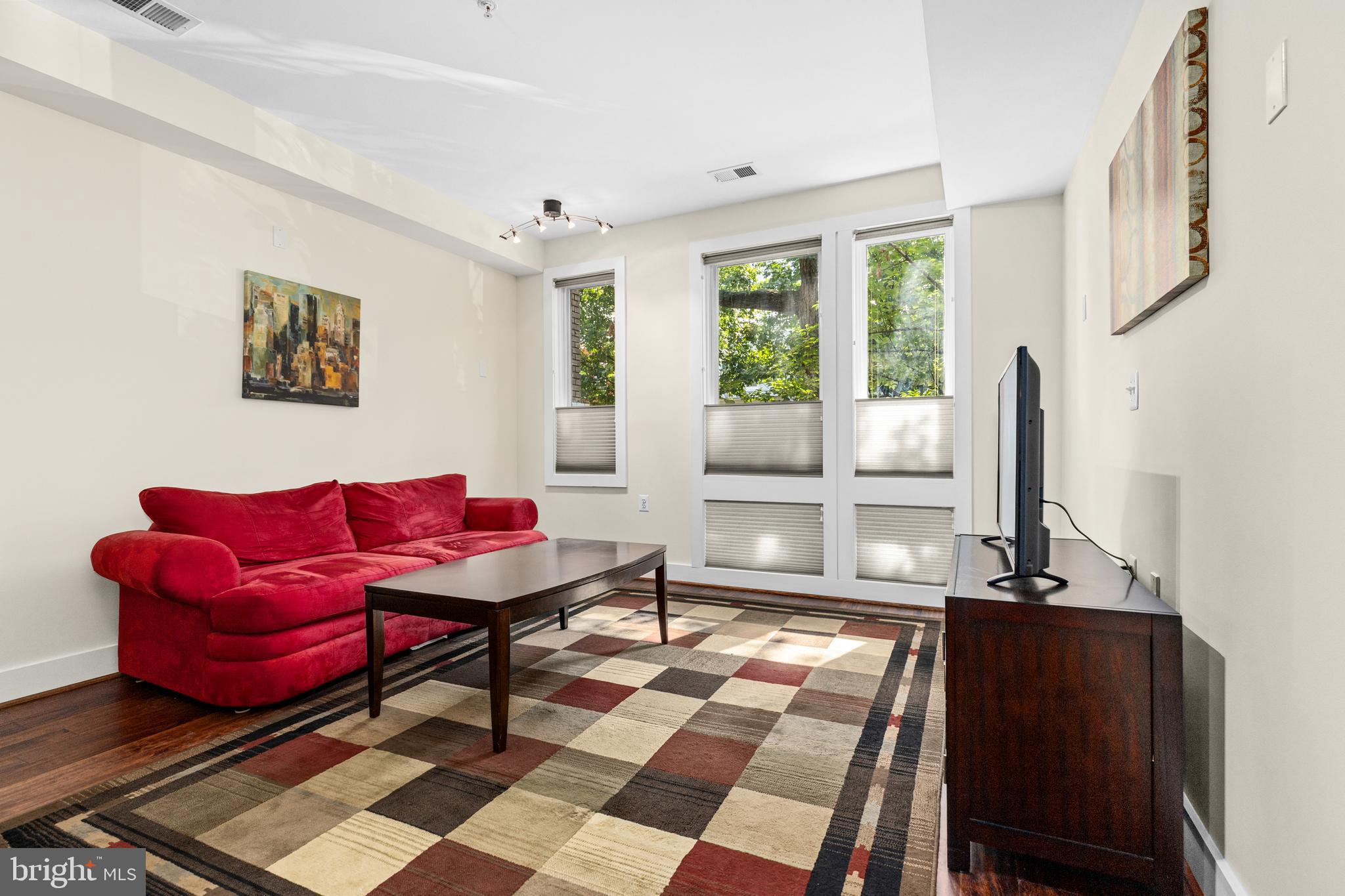 245 15th Street Southeast, Unit 105 Washington, DC 20003 - Photo 9 of 29 a living room with furniture and a window