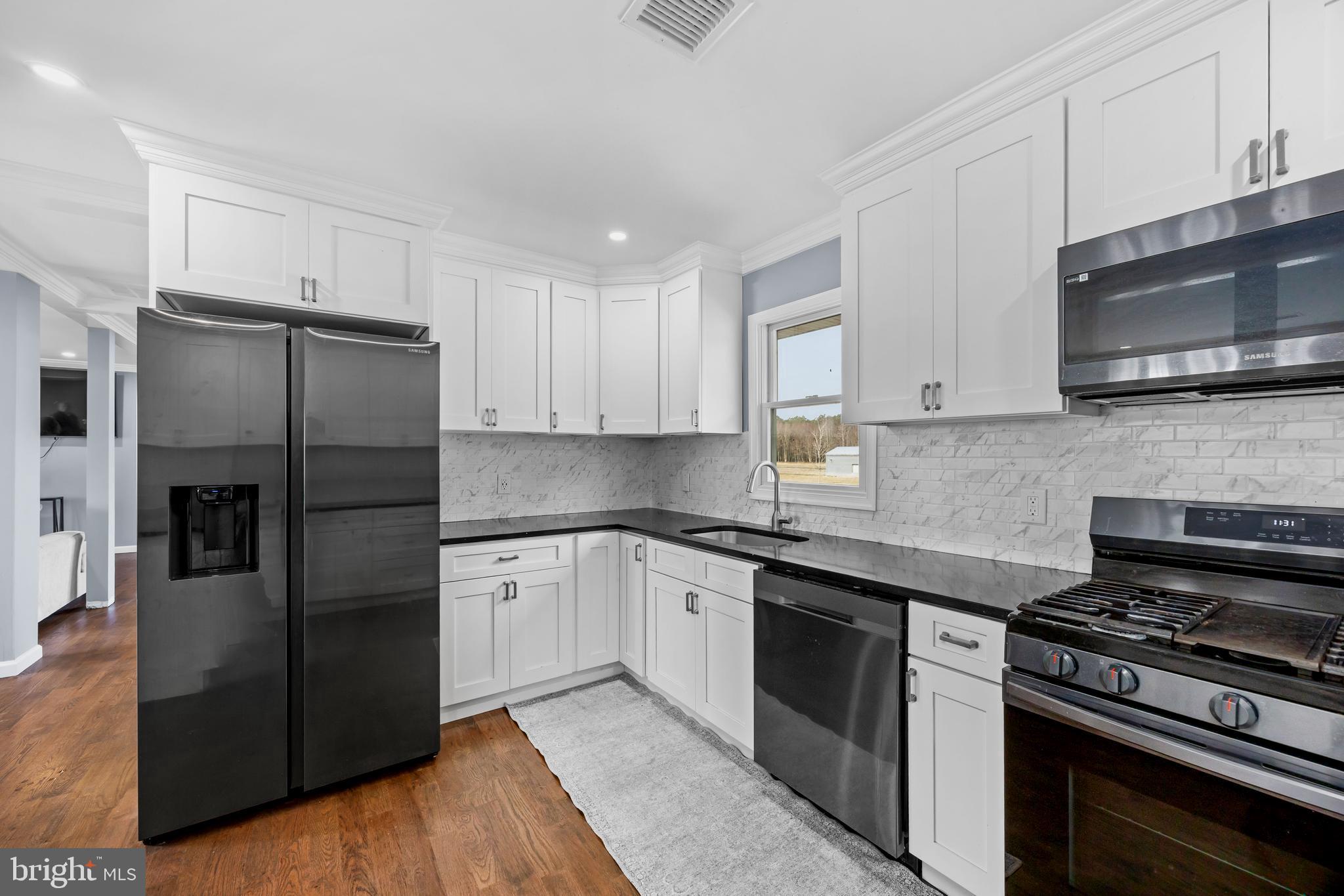 14470 Backbone Road Eden, MD 21822 - Photo 8 of 55 a kitchen with stainless steel appliances granite countertop a stove top oven a refrigerator and a microwave