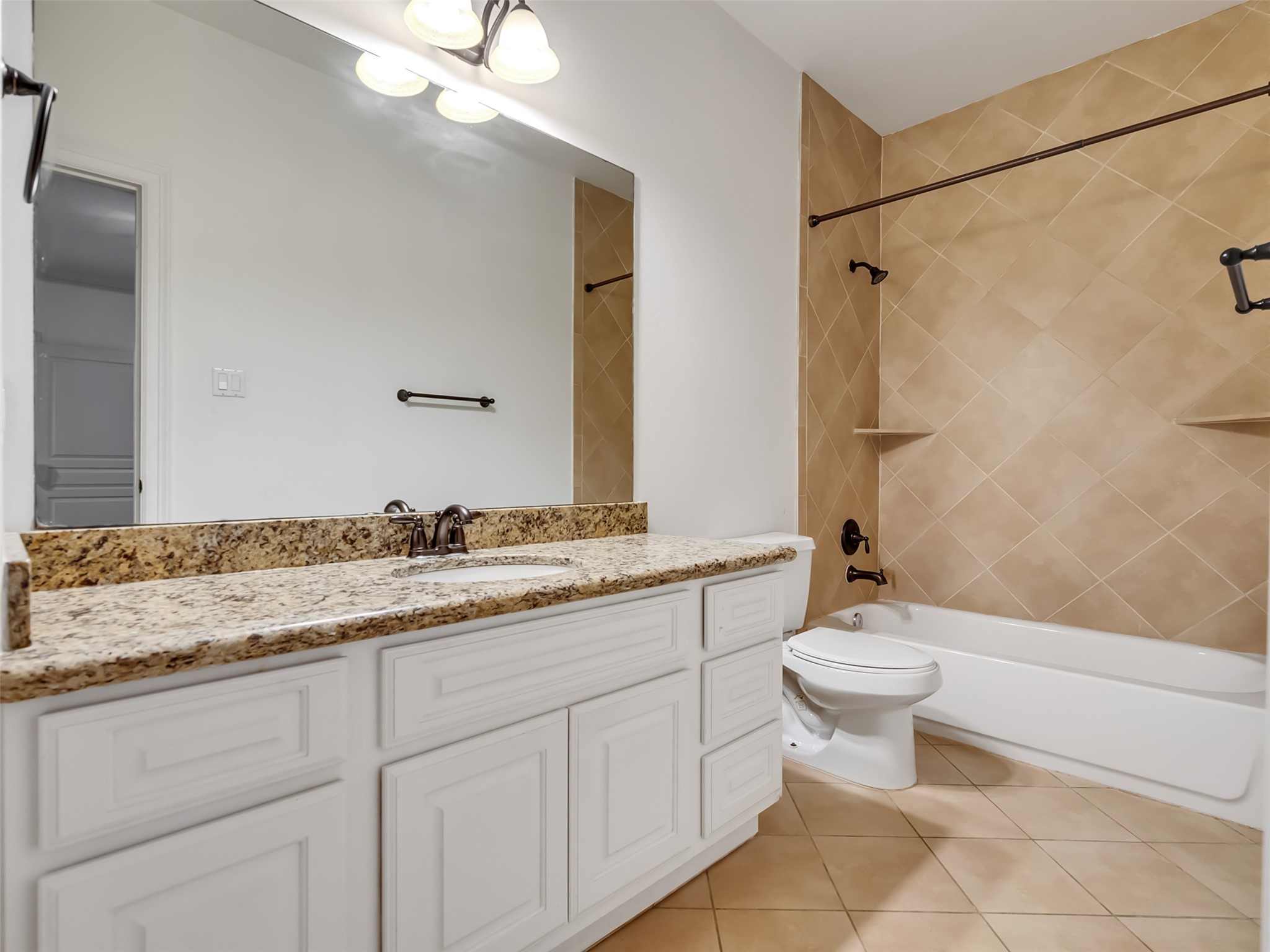 2540 Prospect Street, Unit B Houston, TX 77004 - Photo 7 of 37 a bathroom with a granite countertop sink toilet mirror and a bathtub