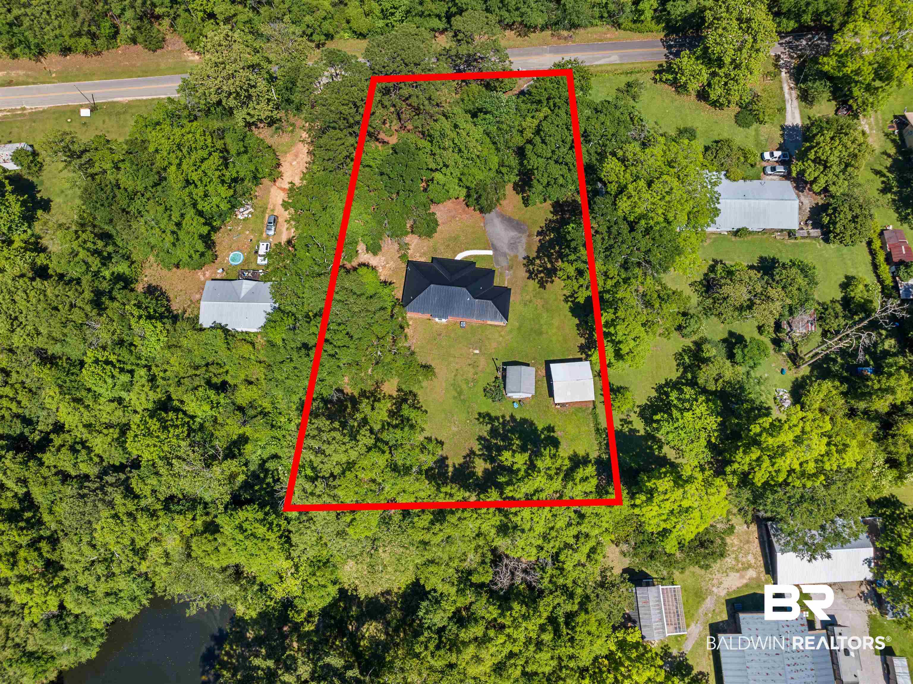 35893 Pine Road South Stapleton, AL 36578 - Photo 24 of 31 Extensive lot featuring a detached residence with a dark roof and two ancillary structures
