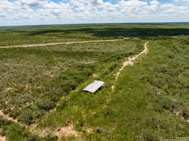 a view of a field with an ocean view