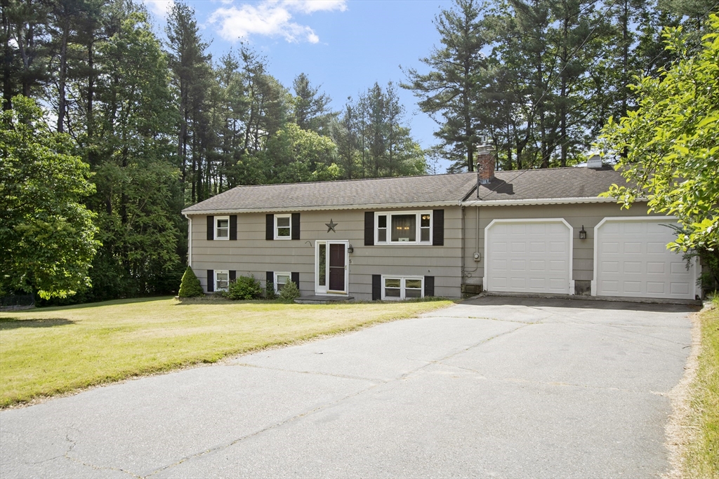 5 Stonybrook Road Chelmsford, MA 01863 - Photo 1 of 1 a front view of a house with a yard and trees
