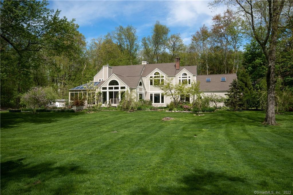 90 Nursery Road New Canaan, CT 06840 - Photo 1 of 1 a front view of a house with a garden