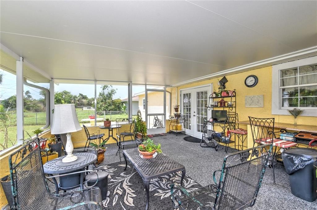19066 Flamingo Road Fort Myers, FL 33967 - Photo 11 of 29 a living room with furniture and floor to ceiling windows