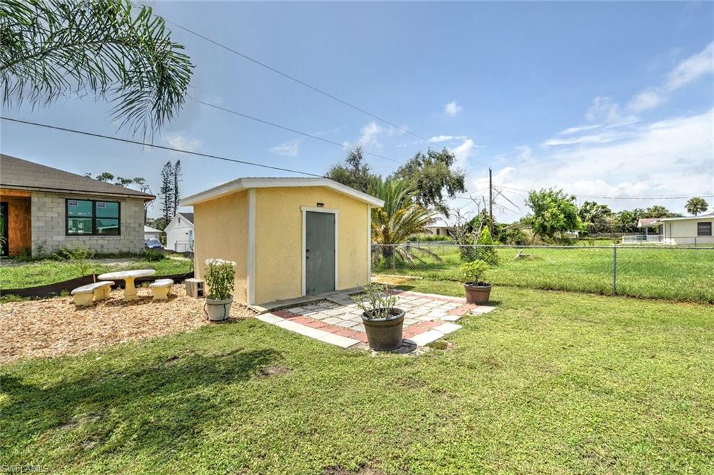 19066 Flamingo Road Fort Myers, FL 33967 - Photo 25 of 29 a backyard of a house with table and chairs