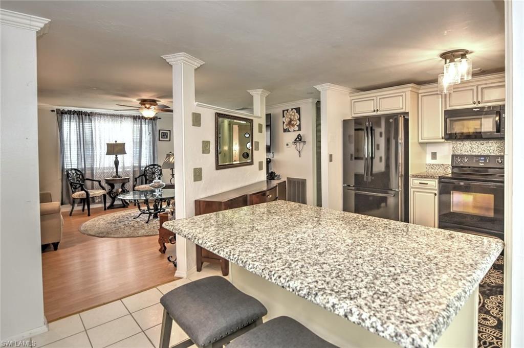 19066 Flamingo Road Fort Myers, FL 33967 - Photo 6 of 29 a living room with dining table and appliances
