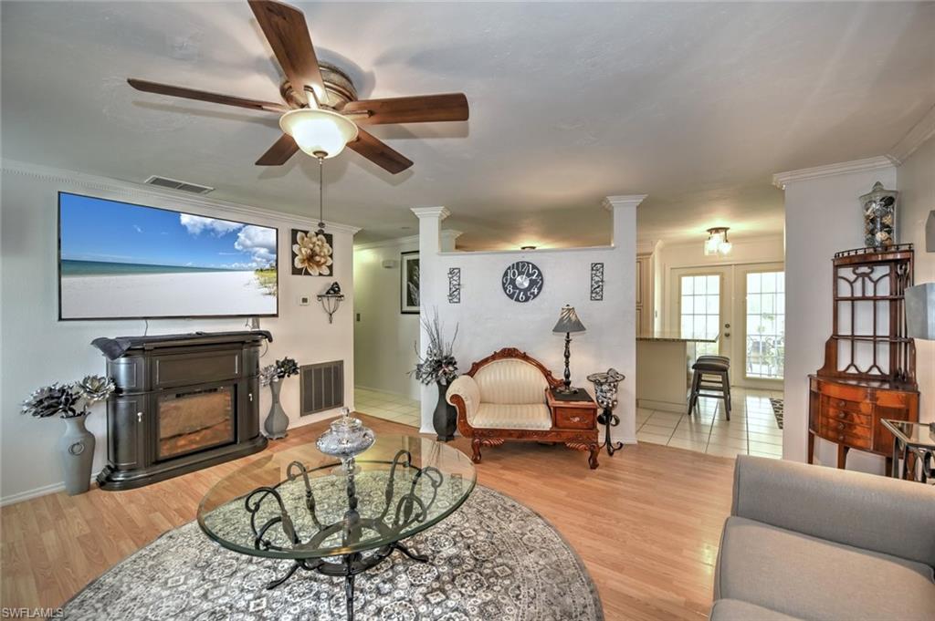19066 Flamingo Road Fort Myers, FL 33967 - Photo 7 of 29 a living room with furniture a flat screen tv and a fireplace