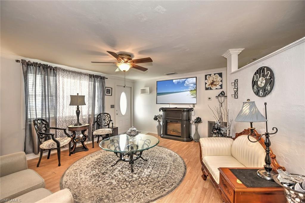 19066 Flamingo Road Fort Myers, FL 33967 - Photo 8 of 29 a living room with furniture a dining table and a fireplace