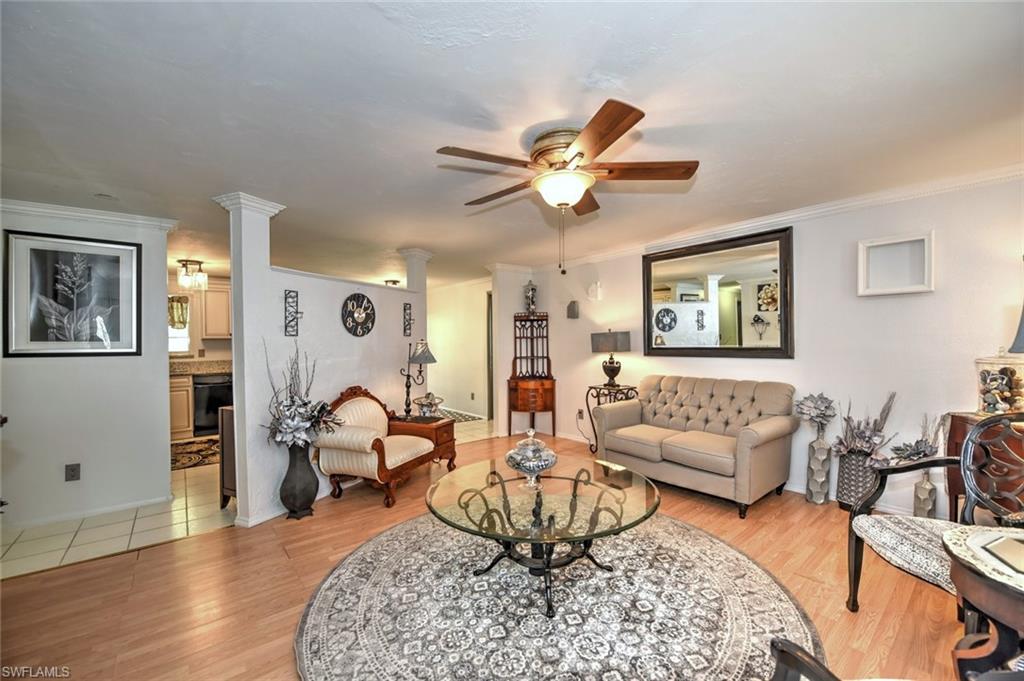 19066 Flamingo Road Fort Myers, FL 33967 - Photo 10 of 29 a living room with furniture a rug and a chandelier