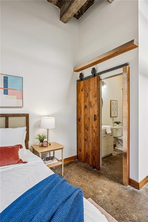 659 Auburn Avenue Northeast, Unit 229 Atlanta, GA 30312 - Photo 19 of 40 a spacious bedroom with a bed and a table in it