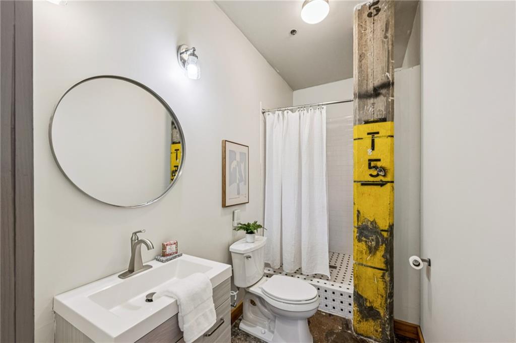 659 Auburn Avenue Northeast, Unit 229 Atlanta, GA 30312 - Photo 21 of 40 a bathroom with a sink a toilet and a mirror
