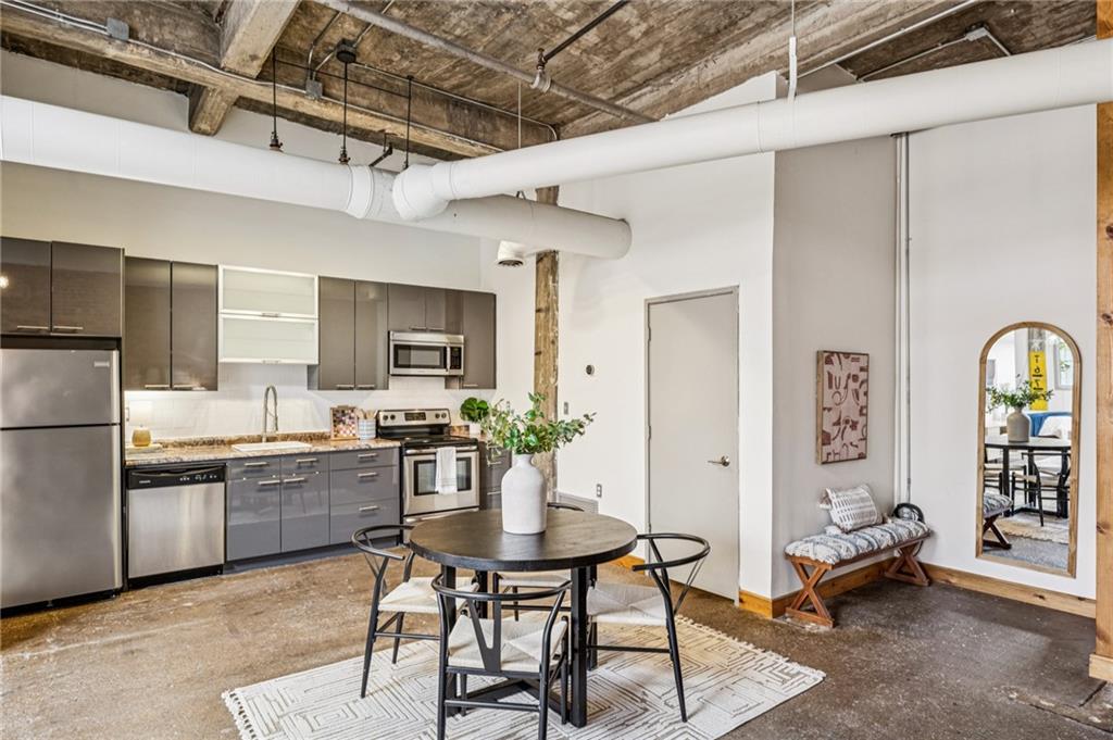 659 Auburn Avenue Northeast, Unit 229 Atlanta, GA 30312 - Photo 7 of 40 a kitchen with refrigerator and cabinets