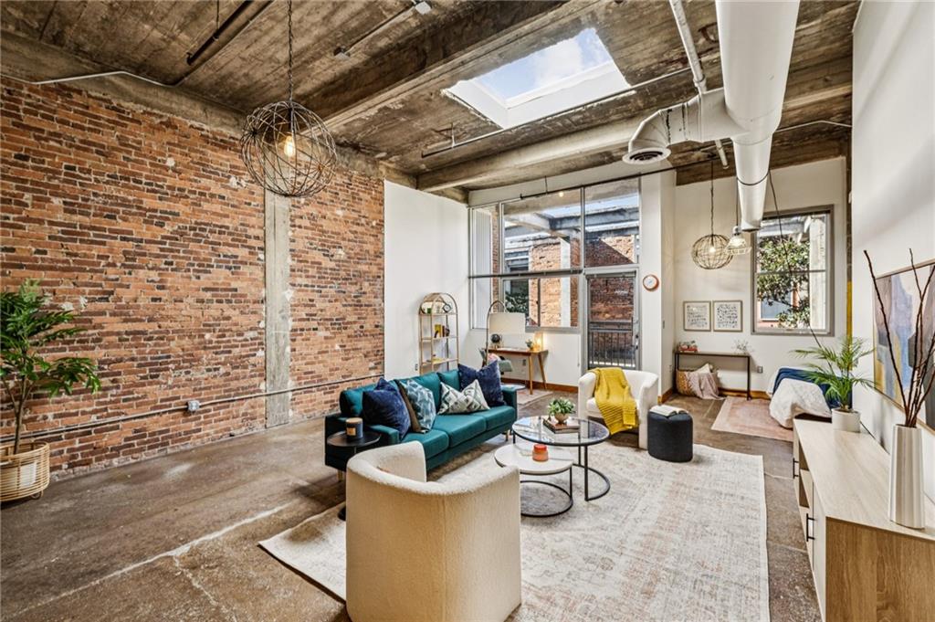 659 Auburn Avenue Northeast, Unit 229 Atlanta, GA 30312 - Photo 10 of 40 a view of a patio with couches and potted plants on the wall