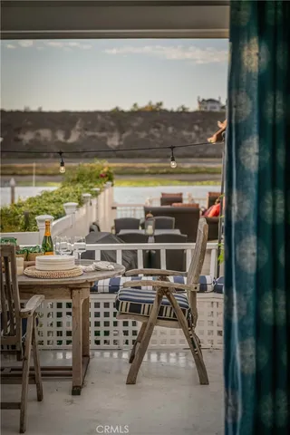 a view of a balcony with chairs and iron fence