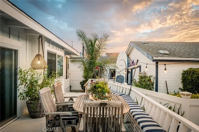 a view of a patio with table and chairs and potted plants