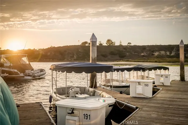 a table and chairs sitting on a deck with a white roof