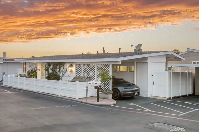 an aerial view of a residential building with outdoor space and ocean view