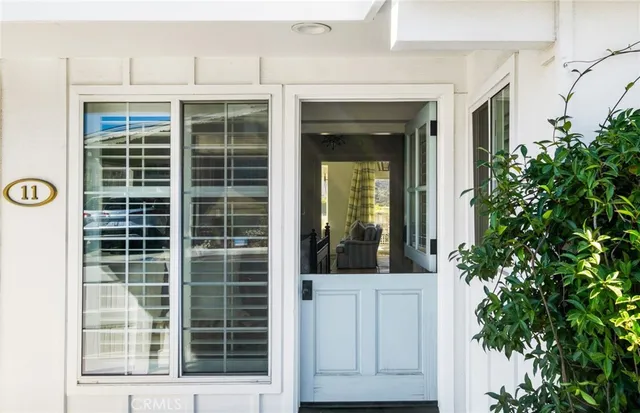 a kitchen with stainless steel appliances a stove a sink cabinets and wooden floor