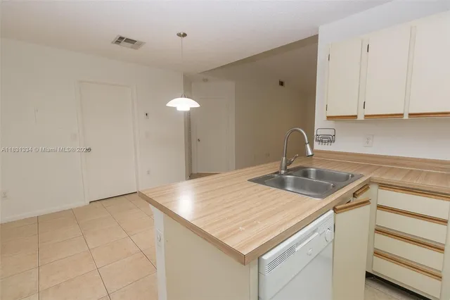 a kitchen with a sink cabinets and wooden floor