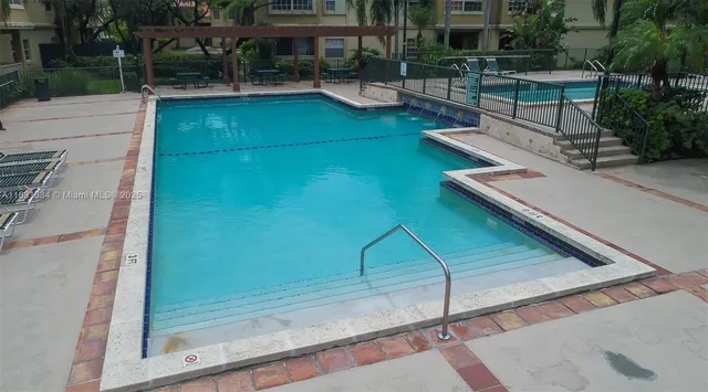 a view of swimming pool with outdoor seating and plants
