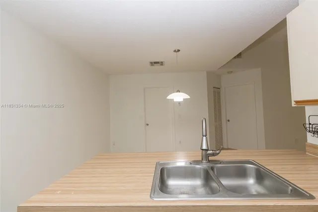 a close view of a sink a mirror and vanity